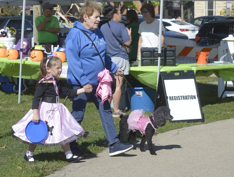 If you own a poodle, you must wear a poodle skirt as Cadence Bragg did as she walks the grounds with Char Bragg on Sunday, Oct. 6, 2024, during the annual Bill’s Barktoberfest on the Jordan block in Ottawa.