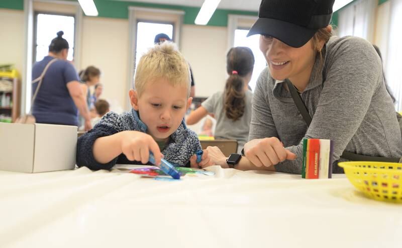 Cal Shoemaker of Downers Grove helps color a mural next to his mother Sam during the Unplug Illinois Day held at the Downers Grove Park District Saturday July 8, 2023.