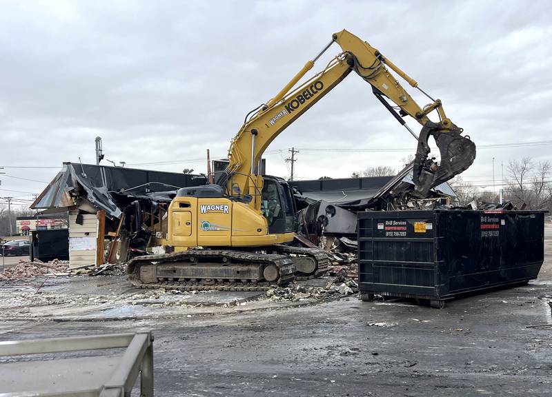 An excavator dumps debris from Tom & Jerry’s into a dumpster Thursday, Feb. 19, 2026, as teardown is underway at the popular Sycamore restaurant after it was destroyed by fire Jan. 31. The eatery plans to reopen soon at 265 W. Peace Road while they rebuild at the original location.