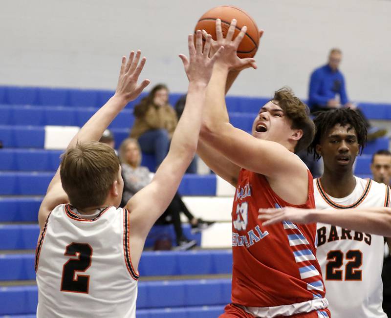 Marian Central's Cale McThenia drives to the basket assigns DeKalb's Sean Reynolds  during a Central High School’s Dr. Martin Luther King, Jr., Boys Basketball Tournament game Friday, Jan. 13, 2023, at Central High School in Burlington.