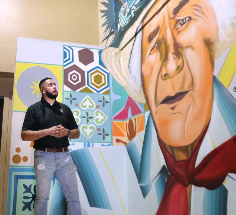 One of the co-owners of El Jimador Mexican Grill, Christopher Cardenas, talks Thursday about the mural on the wall in the stairway of the new restaurant in DeKalb. The mural was painted by Sycamore artist Brett Whitacre and depicts co-owner Rudy Hernandez's grandfather, Tomas Sanches, a jimador, which is is someone that harvests the agave plant. The restaurant is planning to open in the last weekend in September.