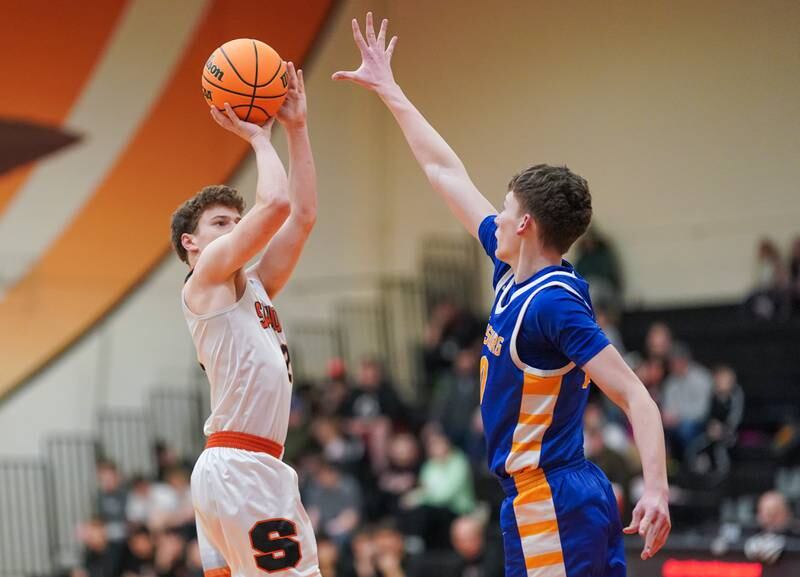 Sandwich's Griffin Somlock (2) shoots a three pointer against Johnsburg's Joshua Kaunas (20) during a basketball game at Sandwich High School on Friday, January 31, 2025.