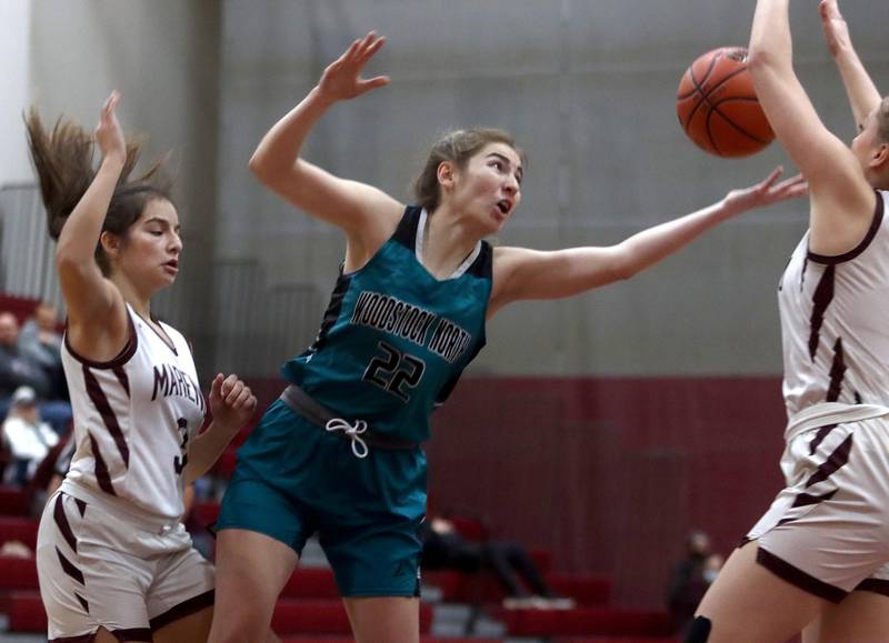 Marengo’s Keatyn Velasquez, left, defends as Woodstock North’s Reagan Ungaro tries to get a handle on the ball in girls basketball at Marengo on Thursday.