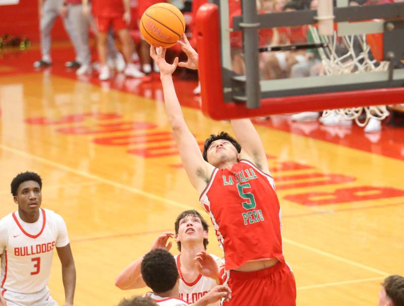 L-P's Erick Sotelo reaches up to grab a rebound against Streator on Tuesday, Jan. 13, 2026 in Pops Dale Gymnasium at Streator High School.