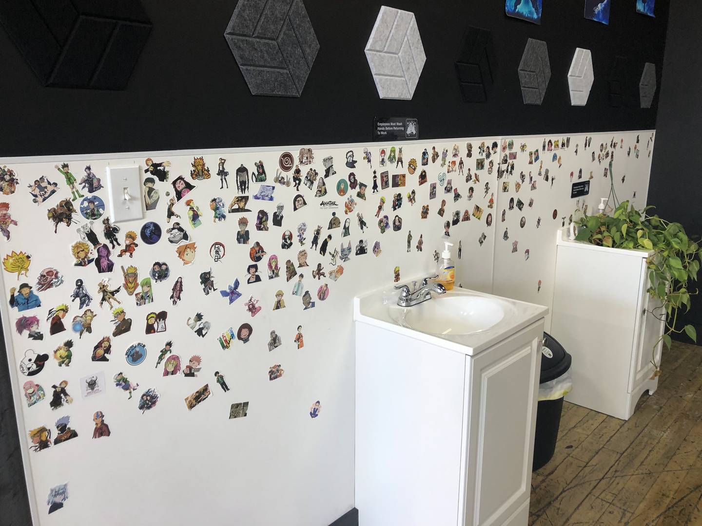 A photo of Irezumi's "sticker wall" on Saturday, Oct. 29, 2022. Each customer signs and places a sticker on the wall to celebrate their new tattoo.