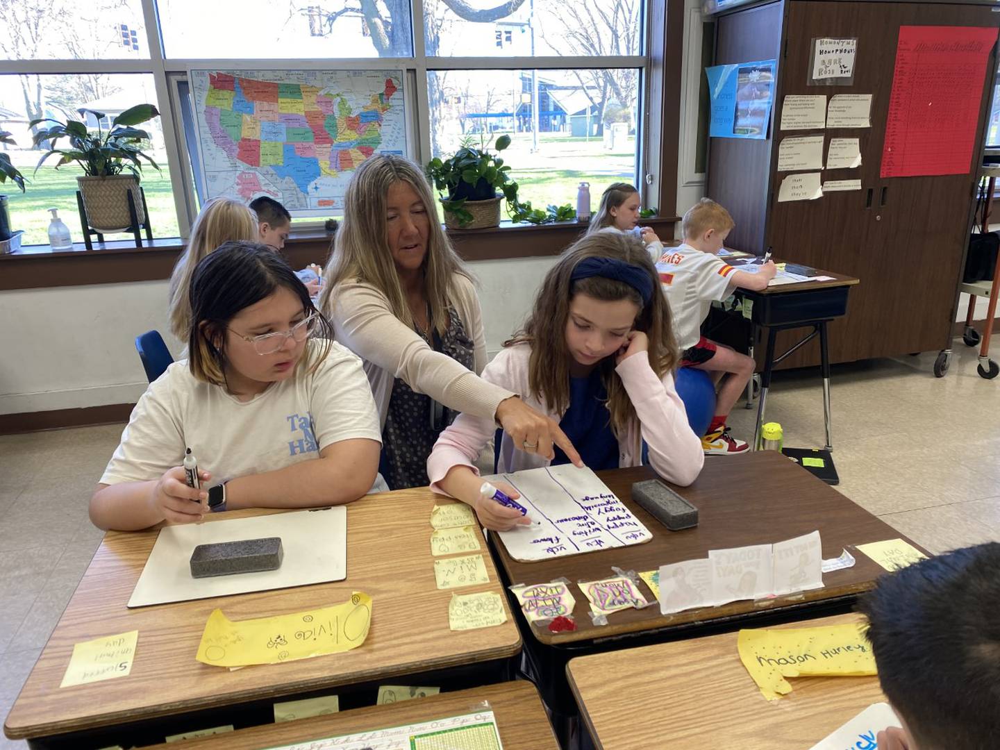 Betsy Cowherd explains a lesson to a student during class.