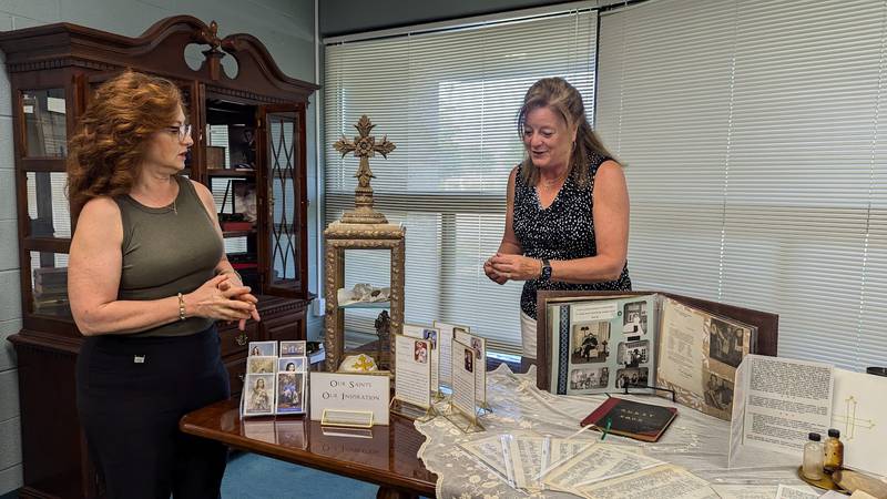 Tanya Rand, celebration chairwoman at St. Paul the Apostle Catholic Church in Joliet, and Kim Krumviede, St. Paul’s business manager, discuss and arrange artifacts for Sunday' s celebration on Wednesday, June 19, 2024, at St. Paul the Apostle Catholic Church in Joliet.