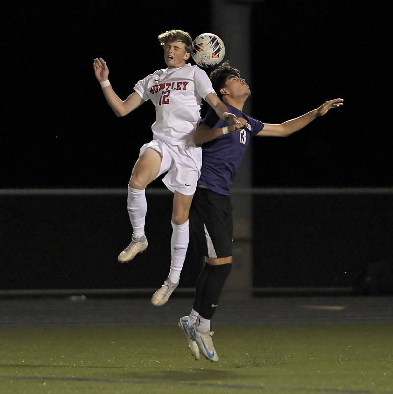 Hampshire’s Edgar Perez and Huntley’s Aiden Felz compete for a header in an IHSA Class 3A boys soccer sectional semifinal game in Streamwood on Oct. 30, 2024.