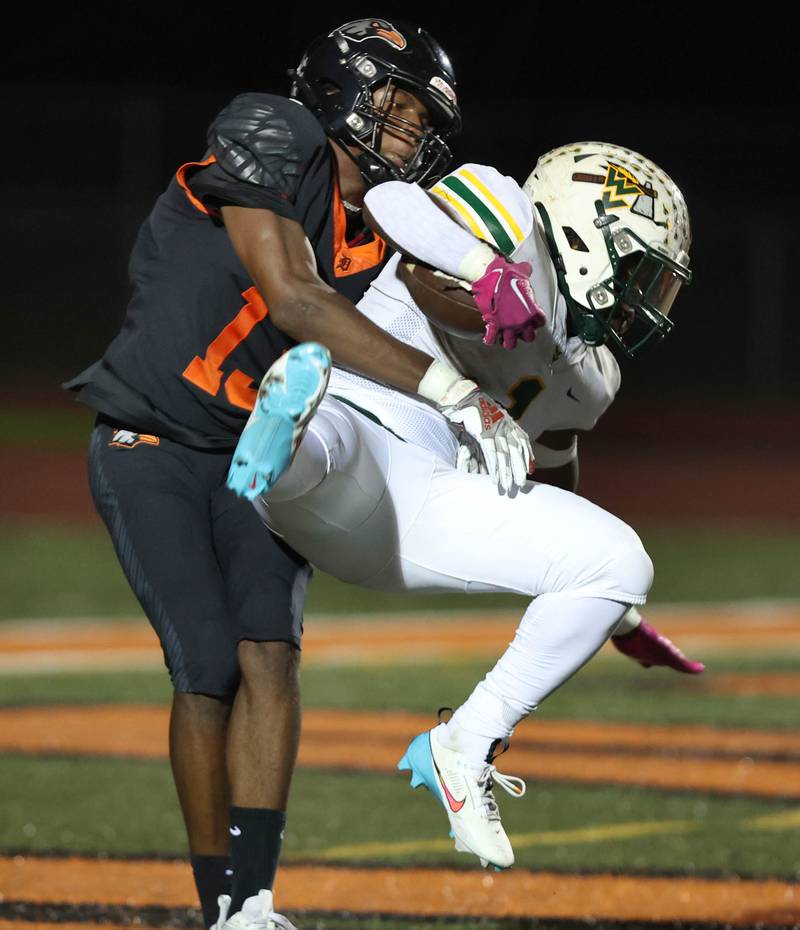 DeKalb’s Davon Grant tackles Waubonsie Valley's Chrisjan Simmons just after he crossed the goal line for a touchdown during their game Friday, Sept. 29, 2023, at DeKalb High School.