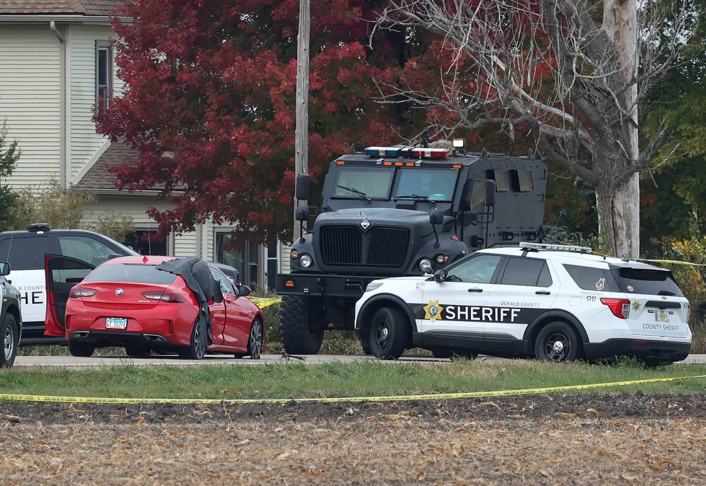 The vehicles involved in fatal police shooting remain in place Wednesday, Oct. 23, 2024, on Rich Road just west of Nelson Road in DeKalb Township as DeKalb County sheriff's deputies and law enforcement authorities continue to investigate. A man was shot and killed by police after an hours-long standoff involving a hostage. The man allegedly fired multiple rounds at officers, who returned fire, authorities said.