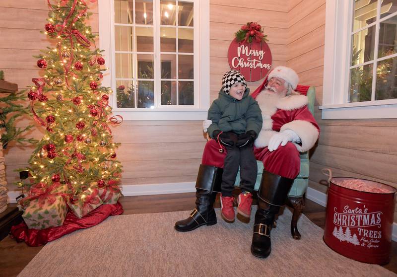 Corbin Schaefer, 7 of North Aurora visits with Santa in the new Santa Cottage during the Lighting of the Lights Ceremony at 1st Street Plaza on Friday, Nov 28, 2025 in St. Charles.