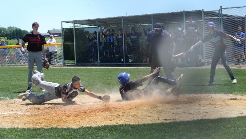 Forreston catcher Mikey Probst reaches to try and tag East Dubuque's Angel Reyes, but Reyes beats the throw to score the winning run in the championship game of the 1A  Forrestion Sectional on Saturday, May 25, 2024 at Forreston High School. East Dubuque scored two runs in the top of the seventh inning to edge the Cardinals 4-3 and move on to the supersectional.