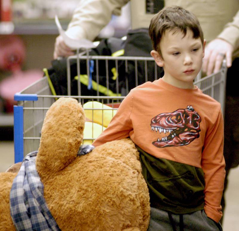 Tommy Parker ponders some gifts Saturday, Dec. 13, 2025, at Sterling Walmart during a shopping trip with Whiteside County sheriff's deputies.