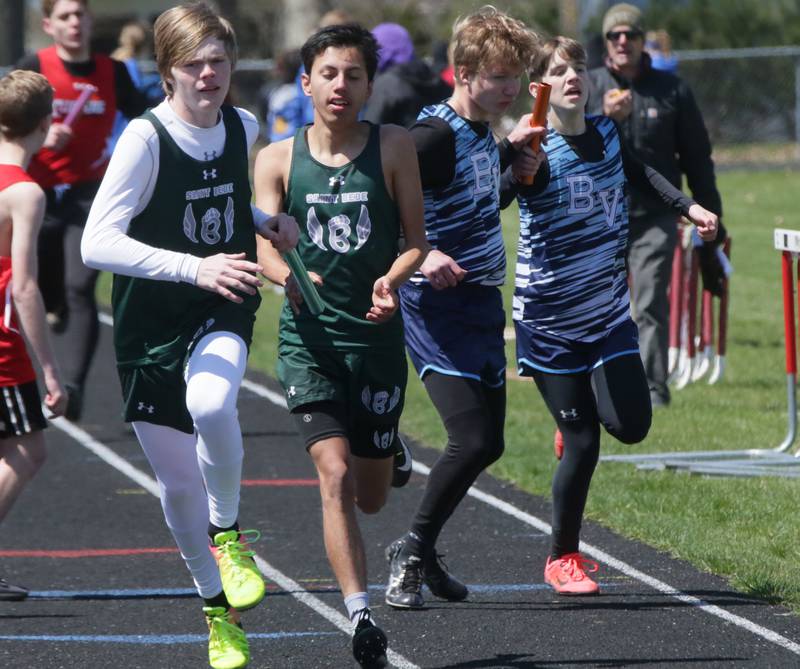 (From left) St. Bede's Grayson Marincic and Miguel Jones and Bureau Valley's Cameron Stodghill and Ryan Wasilewski run in the 4x800 relay during the Rollie Morris Invite on Saturday, April 16, 2022 at Hall High School in Spring Valley.