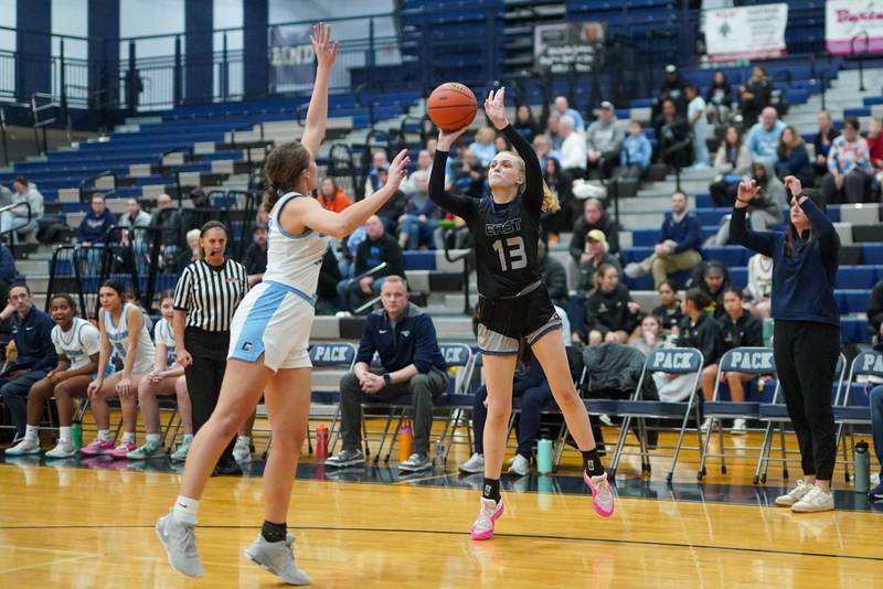 Oswego East's Cassie Van Meter (13) shoots a three pointer against Downers Grove South's Addison Bryant (23) during a 4A Oswego East Regional semifinal girls basketball game at Oswego East High School on Monday, Feb 12, 2024.