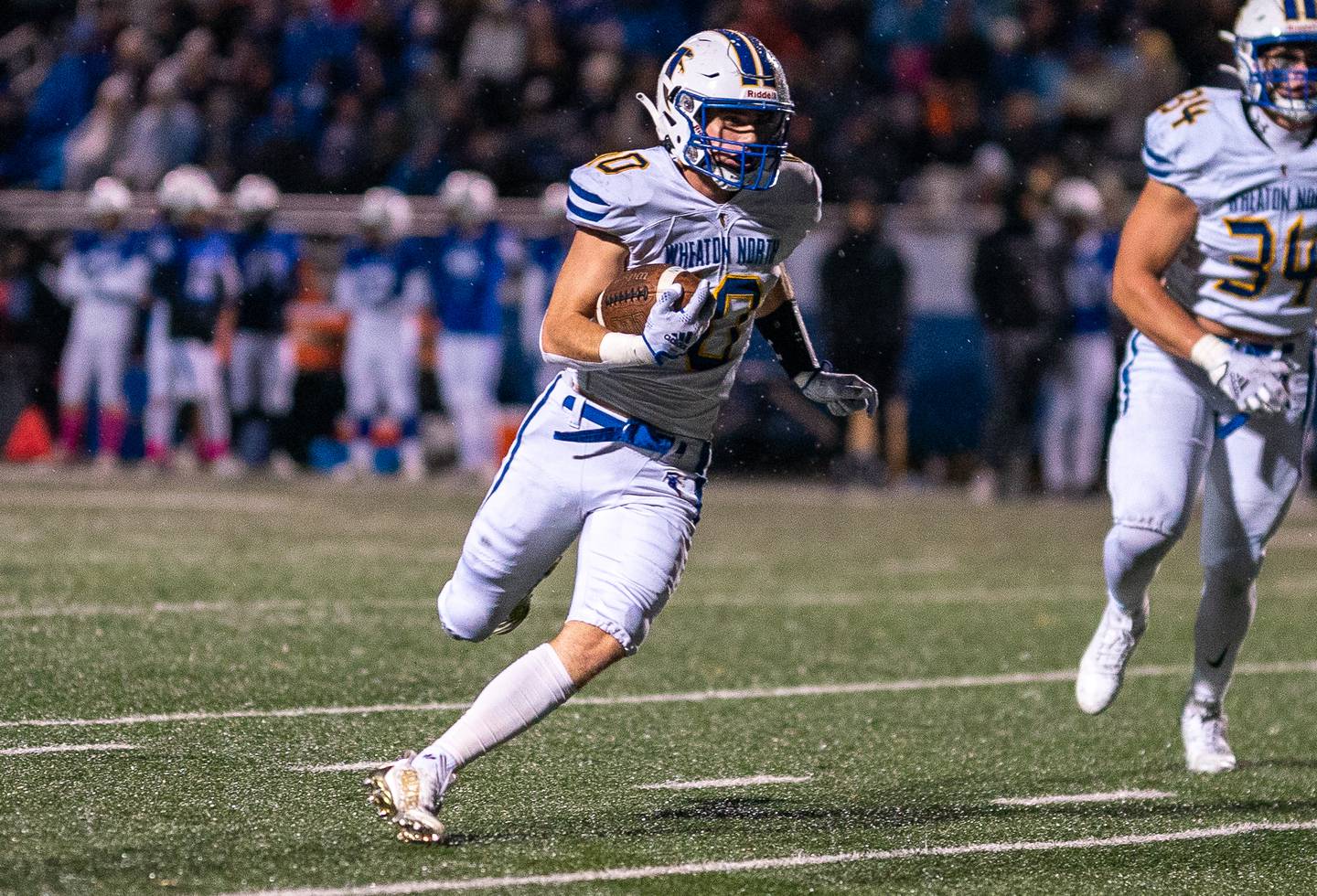 Wheaton North’s Tyler O'connor (10) carries the ball against Geneva during a football game at Geneva High School on Friday, Oct 14, 2022.