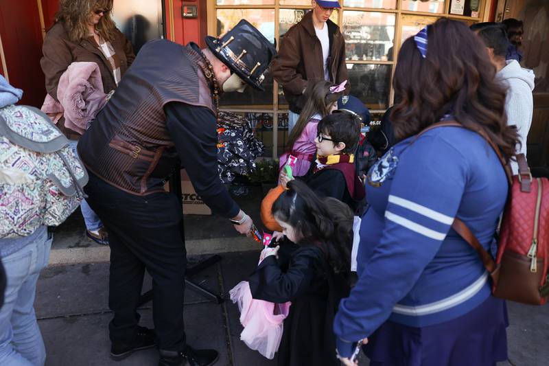 A Harry Potter family gets candy from Moe Joe’s at the annual Halloween Spooktacular in downtown Plainfield on Saturday, Oct. 28, 2023.