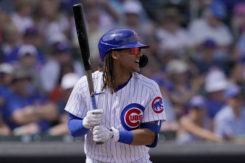 Chicago Cubs' Michael Hermosillo hits against the San Diego Padres during a spring training game on March 19, 2022, in Mesa, Ariz.