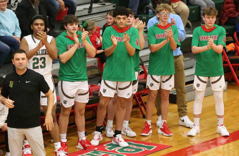 Members of the L-P boys basketball team clap in the final minute as they go on to defeat Morris in Sellett Gymnasium on Friday, Jan. 13, 2023 at L-P High School.