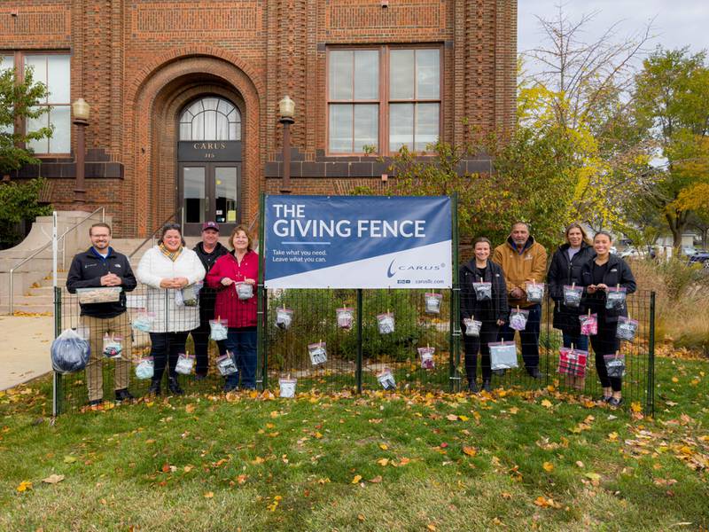 Carus is pleased to announce the third annual unveiling of the Holiday Giving Fence, a beloved community initiative dedicated to offering new and gently used winter apparel to those in need.