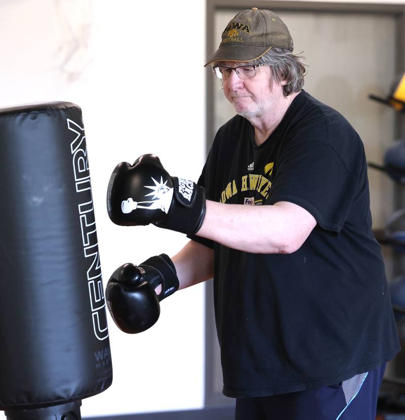 Loren Foelske hits the bag Friday, April 28, 2023, during Rock Steady Boxing for Parkinson's Disease class at Northwestern Medicine Kishwaukee Health & Wellness Center in DeKalb. The class helps people with Parkinson’s Disease maintain their strength, agility and balance.