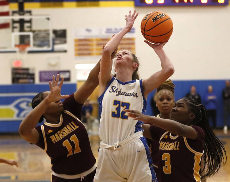Johnsburg's Skye Toussaint tries to shoot the ball between Chicago Marshall's Anabel Robinson (left) and Monay Robinson (right) during a IHSA Class 2A Johnsburg Sectional girls basketball semifinal game on Tuesday, February, 24, 2026, at Johnsburg High School.