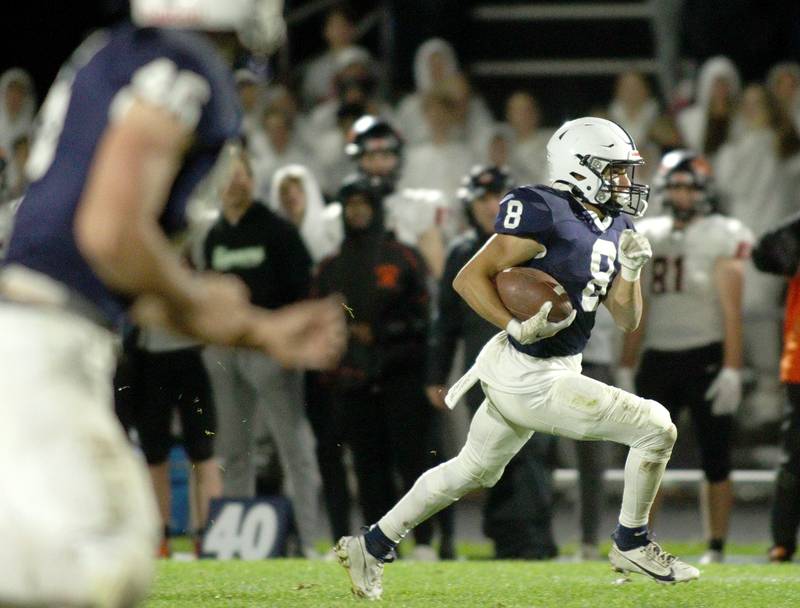 Cary-Grove’s Andrew Prio runs the ball against Libertyville  in first-round Class 6A playoff  football action at Cary Friday.