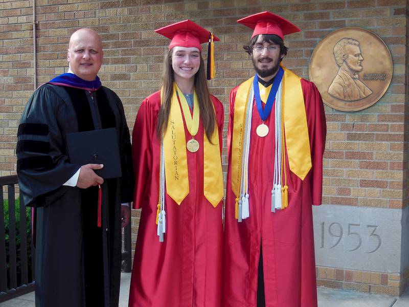 Lincoln-Way Central Principal Steve Provis congratulates valedictorian Daniel Zolecki and salutatorian Madeline McLaughlin before graduation ceremonies for the Class of 2015.