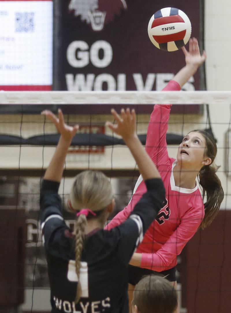 Huntley's Izzy Whitehouse (right) hits the ball past the block of Prairie Ridge's Hailey Muench during a Fox Valley Conference volleyball match on Tuesday, Oct. 14, 2025, at the Prairie Ridge High School in Crystal Lake.
