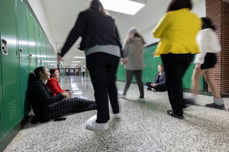 Anjel Henry of Rock Falls (left), Allison Reese of Eastland and Shea Witz of Stockton spend time chatting in the hallway fo RHFS as they await their turn during the speech invite.
