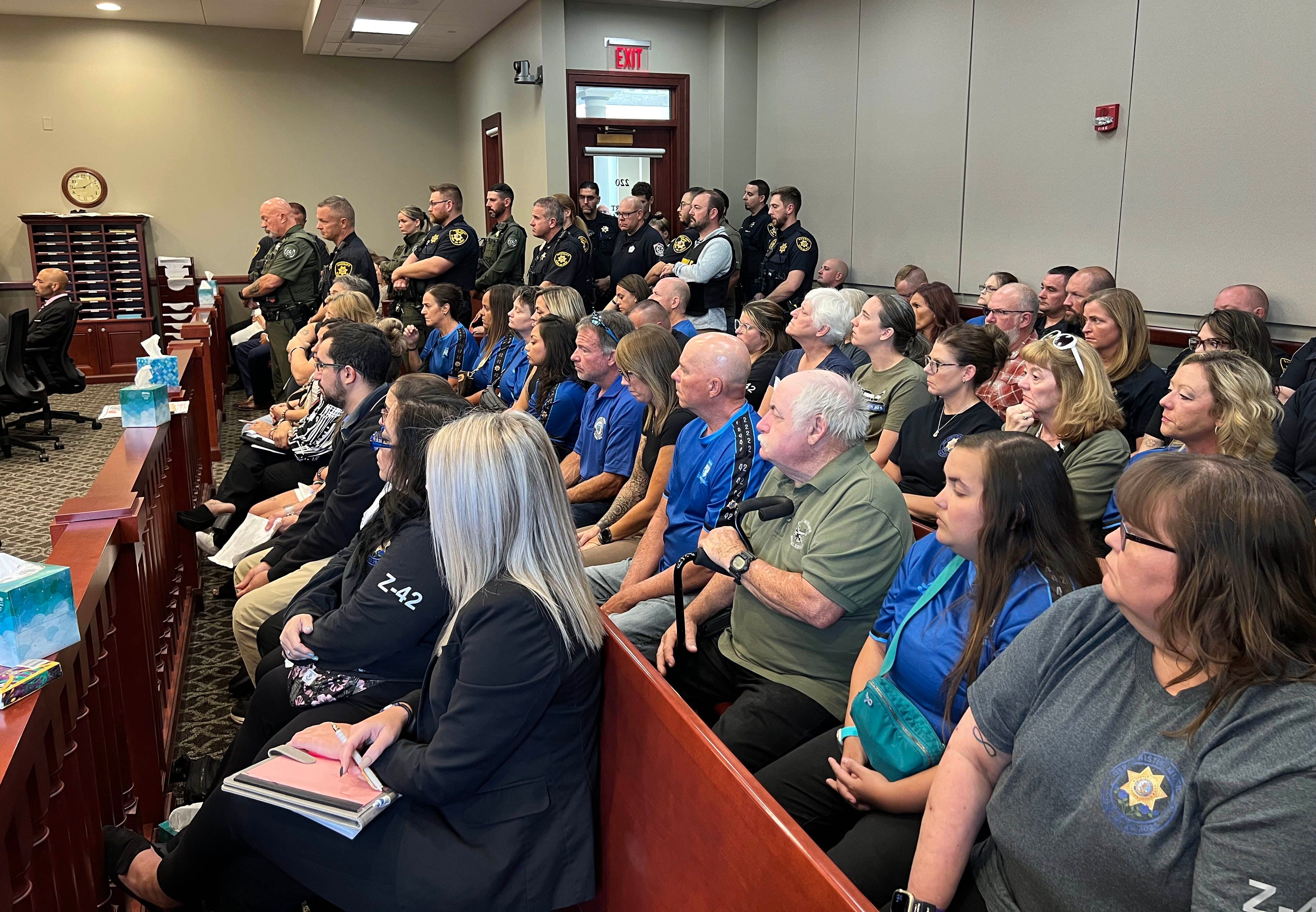 Dozens of law enforcment members along with family and friends of Christina Musil pack the courtroom Tuesday, Aug. 26, 2025, during the sentencing hearing for Nathan P. Sweeney, who pleaded guilty to driving under the influence and causing the 2024 crash that killed Musil. Sweeney was sentenced to the maximum of 14 years.