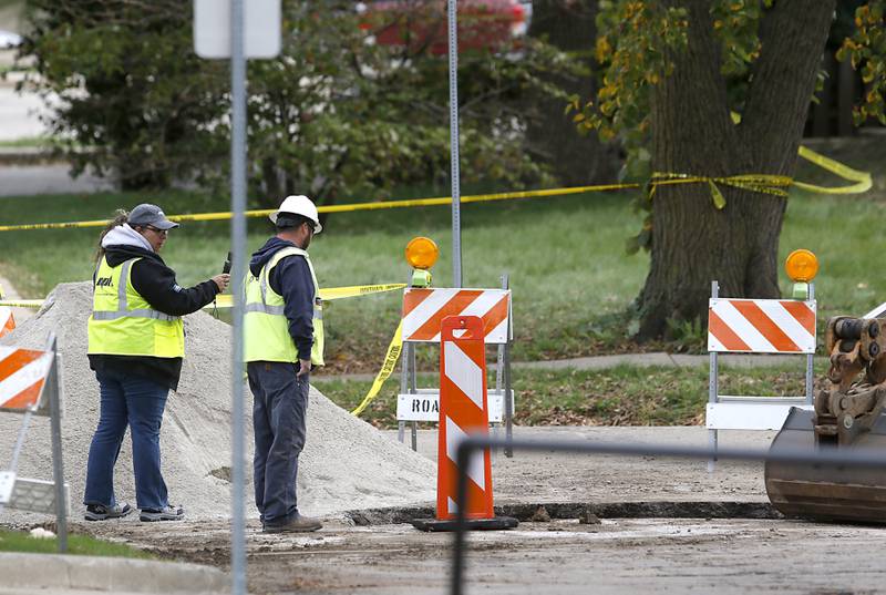 Vallerie Canfield, a claims manager at NPL Construction Co., and a Nicor Gas worker surveys the scene in the 300 block of Lincoln Avenue on Tuesday, October 10, 2023, after an explosion following a gas leak in the area leveled one home as caused several fires.