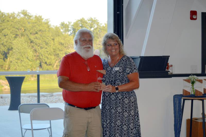 Oregon Area Chamber of Commerce 2023 Volunteer of the Year Brian Grover, left, poses for a photo with Chamber ambassador Joann Canfield after accepting his award. The Chamber's annual awards dinner took place Thursday, Aug. 17, 2023, at River's Edge Experience in Oregon.