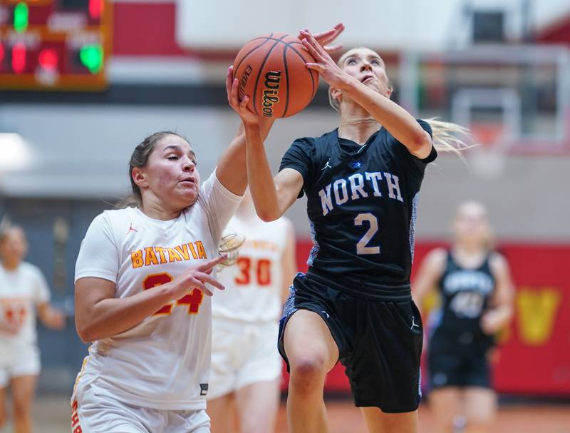 St. Charles North's Reagan Sipla (2) shoots the ball in the post against Batavia’s Hallie Crane (24) during a basketball game at Batavia High School on Tuesday, Dec 5, 2023.