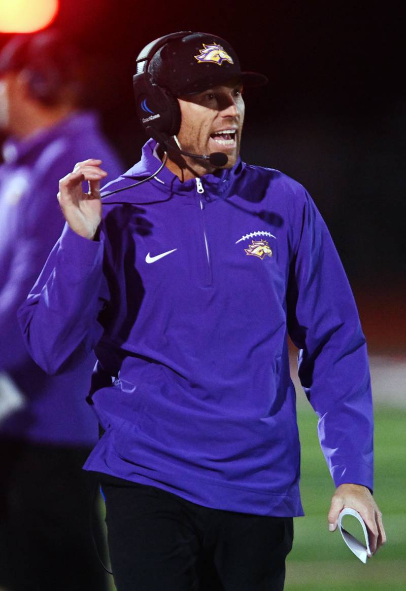 Rolling Meadows football coach Robbie Gould leads the Mustangs against Conant in September 2024 in Hoffman Estates.