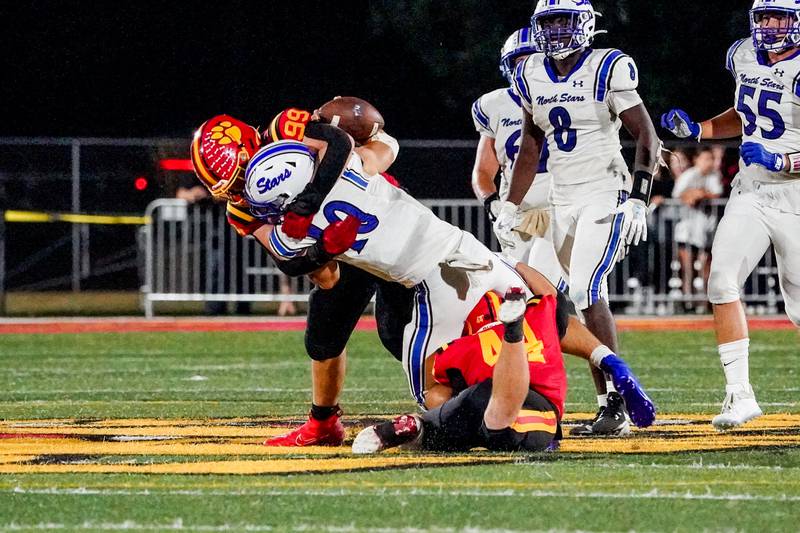 Batavia’s Xavier Blanquel (99) and Jake Feller (44) sack St. Charles North's Ethan Plumb (10) for a loss in the 4th quarter of play during a football game at Batavia High School on Friday, Sep 20, 2024.