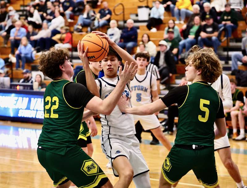 Bureau Valley's Carter Chhim maneuvers against Abingdon-Avon's Ayden Stromsen (22) and Ryker Darst (5) Friday at the Storm Cellar. A-Town won 47-45.