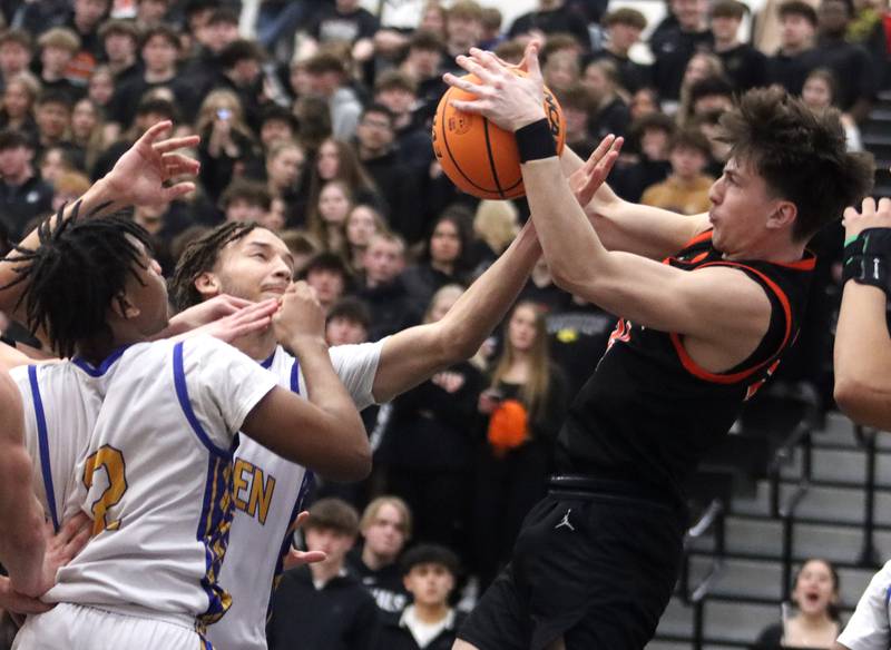 Warren’s Zach Ausburn, left, battles McHenry’s Carter Sites for the ball in IHSA Class 4A Regional Title Game boys basketball action on Friday, Feb. 28, 2025 at McHenry High School in McHenry.