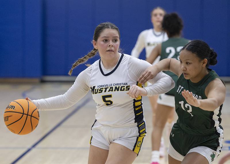 Yorkville Christian’s Hannah Aguado handles the ball against St. Edward’s Madeline Sasis Tuesday, Feb. 25, 2025, in the Class 1A Sectional at Hinckley-Big Rock.