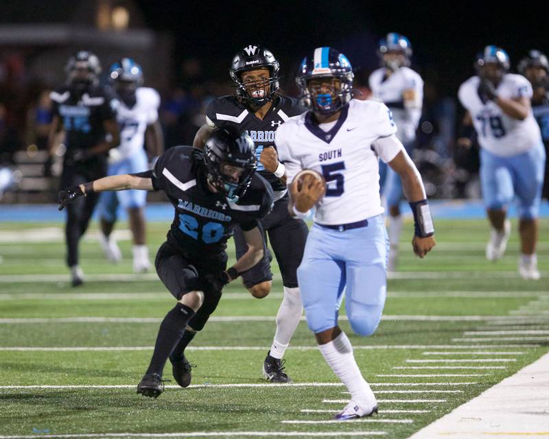 Downers Grove South's Kayden Smith runs the ball for a gain as Willowbrook's Hayden Roscoe looks to run him out of bounds on Friday, Sept. 20, 2024 in Villa Park.