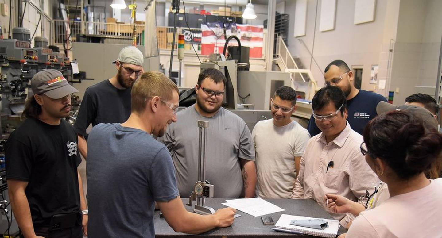 Instructor Justin Gieraltowski, center left, works with Smithfield Food apprentice students in his industrial manufacturing class at Elgin Community College.