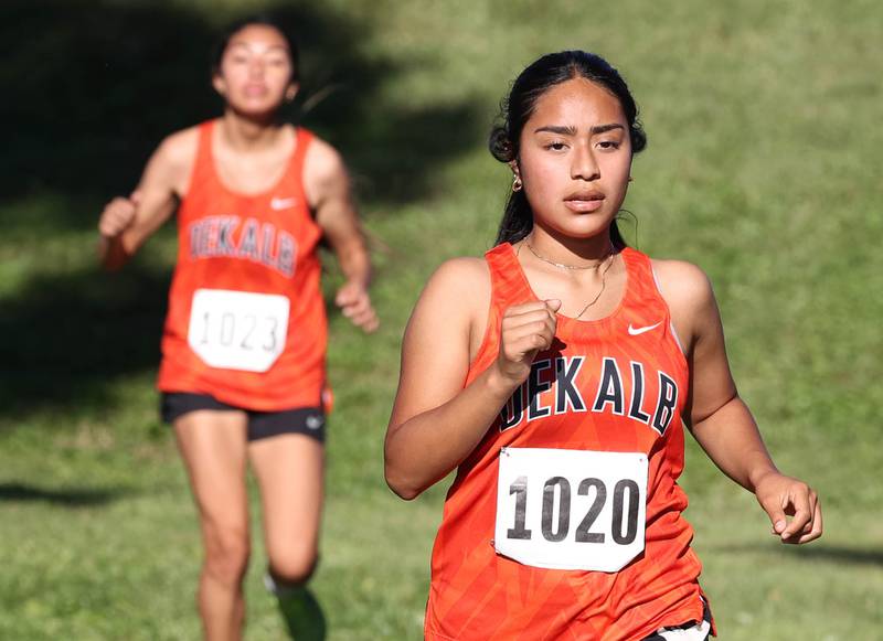 DeKalb’s  Brenda Aquino (right) runs the girls varsity race Tuesday, Sept. 3, 2024, at the Sycamore Cross Country Invite at Kishwaukee College in Malta.