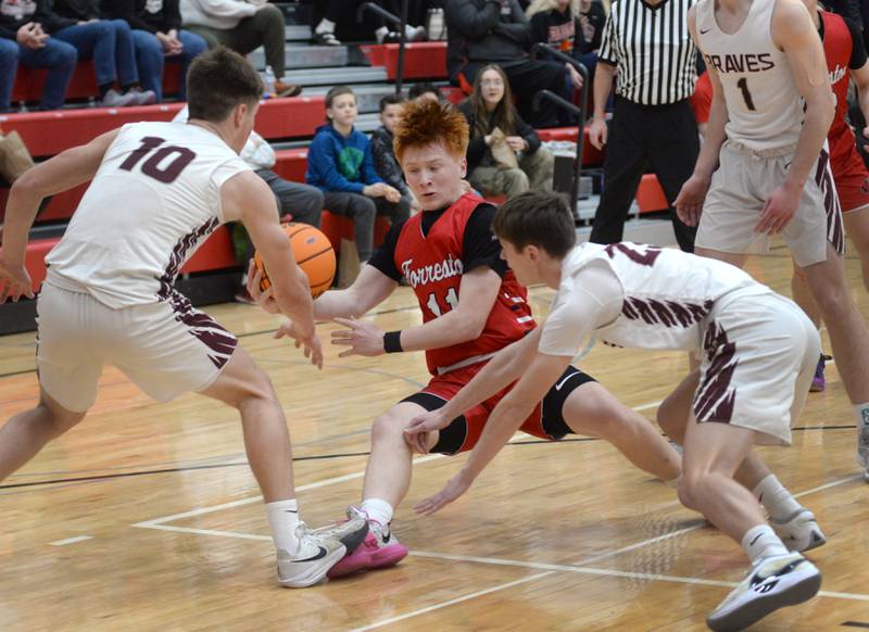 Forreston's Connor Politsch (center) falls to the ground as an Annawan defender steps on his foot during the championship of the 1A Amboy Regional on Friday, Feb. 28, 2025 at Amboy High School.