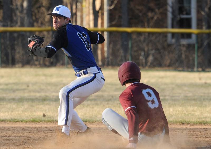 Newark second baseman Payton Wills forces out Morris baserunner Sam Mateski (9) and attempts a double play throw during a varsity baseball game at Newark High School on Wednesday, Mar. 29, 2023.