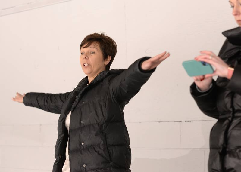 Coach of the Dazzlers synchronized skating team, Debbie Buirge of Woodridge assists her team during practice Wednesday Feb 15, 2023.