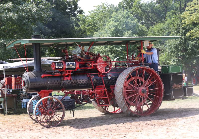 A steam powered tractor lumbers around the grounds Thursday, Aug. 8, 2024, during the 67th annual Sycamore Steam Show and Threshing Bee at Taylor Marshall Farm.