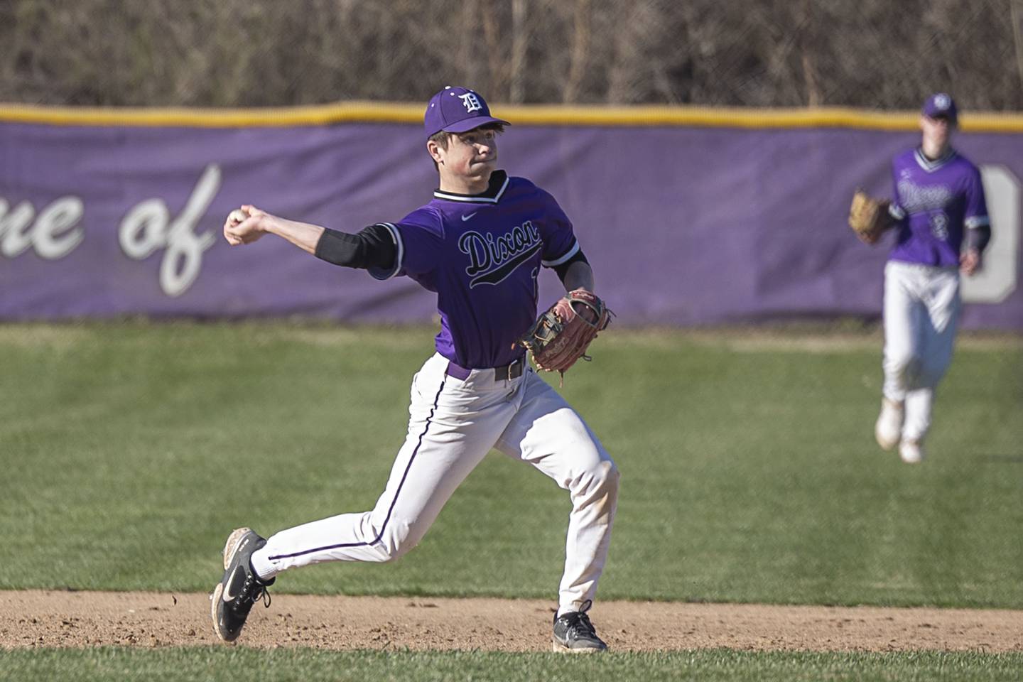 Dixon’s Alex Harrison throws to first for an out against Winnebago Thursday, April 6, 2023.