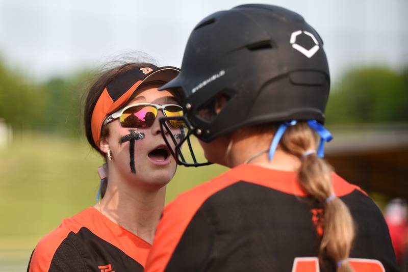 Beecher's Makenzie Johnson, left, gives a pep talk to teammate and sister Allie Johnson, right, during the Class 2A East Peoria Super-Sectional against Brimfield Monday, June 2, 2025.