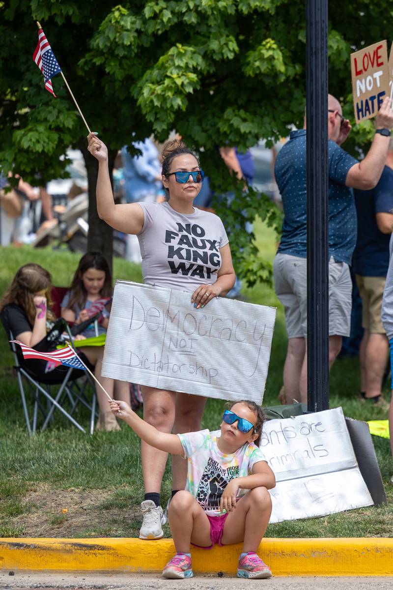 Protesters hold signs and wave flags at the “No Kings” protest on Saturday, June 14, 2025 at Rotary Park in Princeton.
