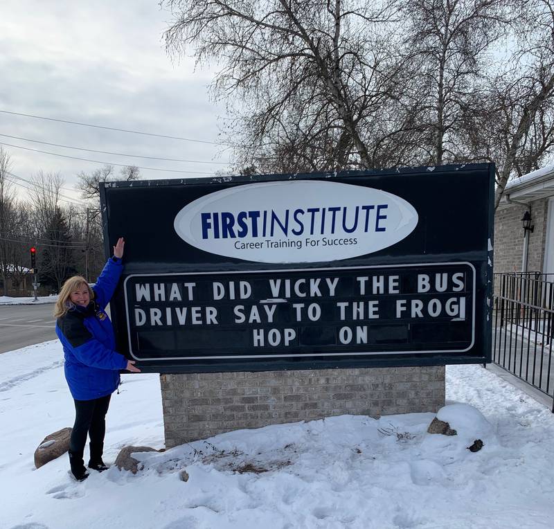 Vicki Masucci West Kropp, a Lake in the Hills resident who work as a school bus driver, stands next to a sign with a message inspired by her in this photo taken on Jan. 30, 2022 outside First Institute, 90 McHenry Road in Crystal Lake.